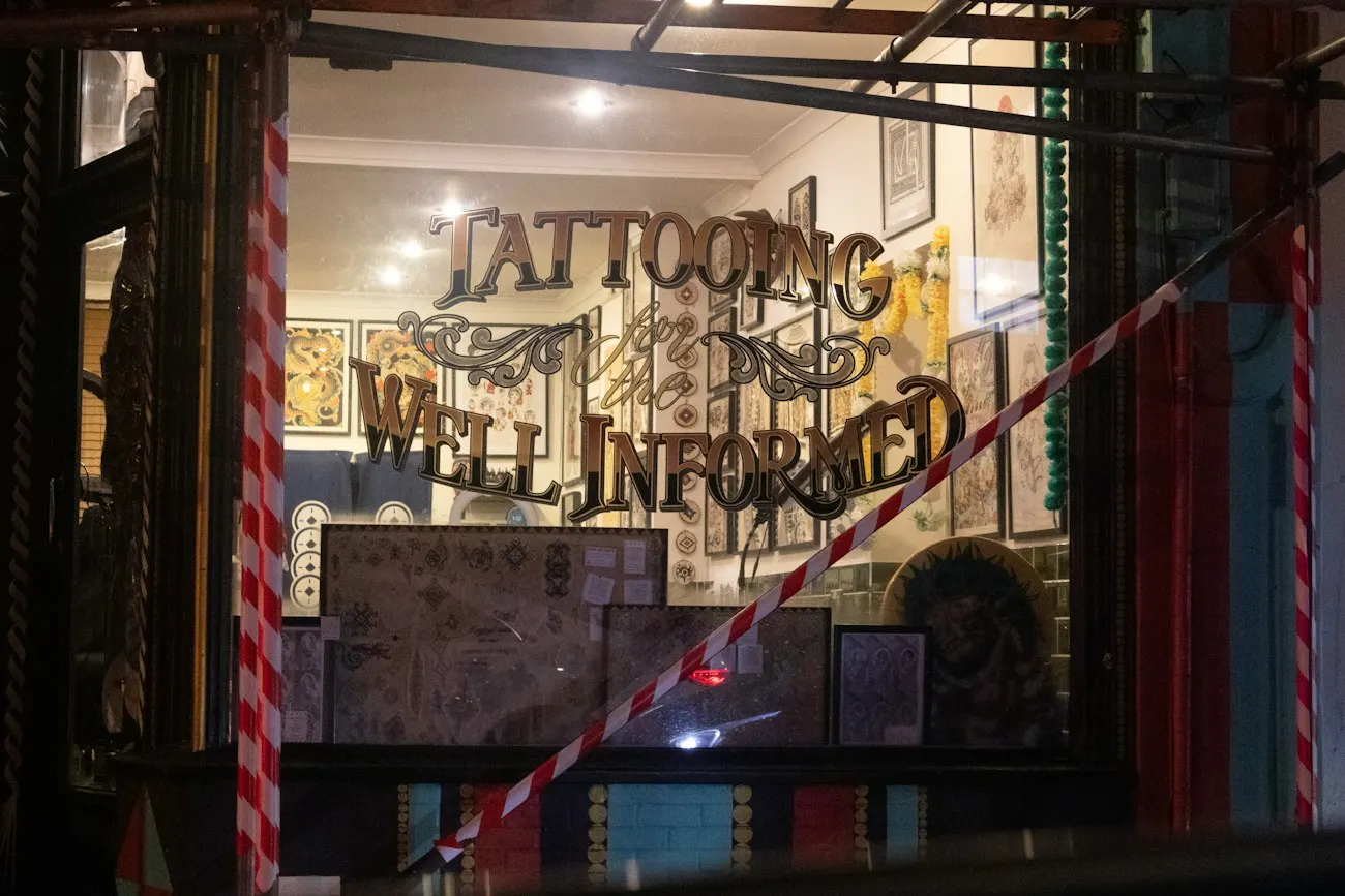 Tattooing well informed sign in shop window