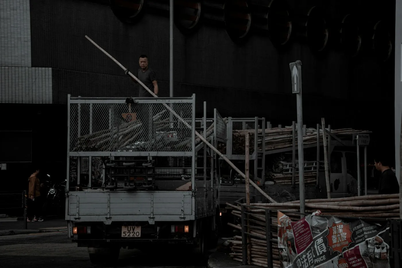 a man standing on the back of a truck